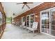 Covered patio with brick walls, ceiling fans, and a seating area, perfect for outdoor relaxation at 182 Meek Rd, Gastonia, NC 28056