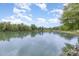 Scenic view of the serene lake or pond, reflecting the clear blue sky and surrounding trees, creating a calming view at 182 Meek Rd, Gastonia, NC 28056