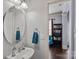 Charming bathroom features a pedestal sink and a glimpse into an inviting living space at 1948 Winpole Ln, Charlotte, NC 28273
