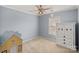 Bedroom with neutral carpet, a ceiling fan, and a decorative armoire at 1948 Winpole Ln, Charlotte, NC 28273