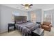 Spacious bedroom featuring a dark wooden bed, multiple windows, and neutral carpet at 1948 Winpole Ln, Charlotte, NC 28273
