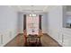Formal dining room with coffered ceiling, wainscoting, hardwood floors, and stylish chandelier at 1948 Winpole Ln, Charlotte, NC 28273