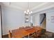 Elegant dining room features hardwood floors, wainscoting, and an open view of the living room at 1948 Winpole Ln, Charlotte, NC 28273