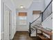 Elegant foyer features hardwood floors, a staircase with dark wood banister, and light-blue walls at 1948 Winpole Ln, Charlotte, NC 28273