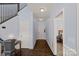 Open foyer with hardwood floors, staircase, wainscoting, and view into the bedroom at 1948 Winpole Ln, Charlotte, NC 28273