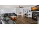 Open living room with hardwood floors, fireplace, and large leather sofa, plenty of open space at 1948 Winpole Ln, Charlotte, NC 28273