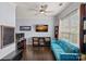 Comfortable living room features a blue sofa, dark hardwood floors, and a modern ceiling fan at 1948 Winpole Ln, Charlotte, NC 28273
