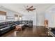 Large living room with hardwood floors, crown molding, large leather sofa, and modern ceiling fan at 1948 Winpole Ln, Charlotte, NC 28273