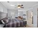 Spacious bedroom featuring a ceiling fan, a bed, and a seating area at 1948 Winpole Ln, Charlotte, NC 28273