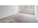 Spacious bedroom with plush carpeting and a large window, offering natural light at 2028 Cedar Falls Dr # 10, Waxhaw, NC 28173