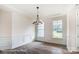 Bright dining room featuring wainscoting, modern chandelier, and hardwood floors at 2028 Cedar Falls Dr # 10, Waxhaw, NC 28173