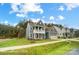 Charming two-story home with a blue exterior, covered porch, two-car garage, and well-manicured lawn at 2028 Cedar Falls Dr # 10, Waxhaw, NC 28173