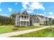 Charming two-story home with a blue exterior, covered porch, two-car garage, and well-manicured lawn at 2028 Cedar Falls Dr # 10, Waxhaw, NC 28173