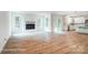 Open-concept living room with wood floors, fireplace, and access to the kitchen at 2028 Cedar Falls Dr # 10, Waxhaw, NC 28173