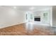 Open-concept living room with wood floors, fireplace, and large windows at 2028 Cedar Falls Dr # 10, Waxhaw, NC 28173