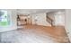 Open-concept living space with wood floors, fireplace, and kitchen at 2028 Cedar Falls Dr # 10, Waxhaw, NC 28173