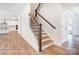 Staircase with wood steps and iron railing, with an open view of the kitchen at 2028 Cedar Falls Dr # 10, Waxhaw, NC 28173