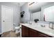 Bathroom featuring double sink vanity, neutral tile flooring, and ample lighting at 2046 E Park Dr, Lancaster, SC 29720