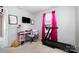 Neutral bedroom with a pink desk, treadmill, television, and a window at 2046 E Park Dr, Lancaster, SC 29720