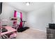 Neutral bedroom with a pink desk, treadmill, and a window at 2046 E Park Dr, Lancaster, SC 29720