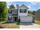 Charming two-story home with gray siding, white accents, and a two-car garage at 2046 E Park Dr, Lancaster, SC 29720