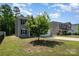 Two-story home featuring vinyl siding, black shutters, a front yard, and an attached one-car garage at 2046 E Park Dr, Lancaster, SC 29720