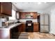 Well-lit kitchen featuring stainless steel appliances, dark cabinetry and neutral countertops at 2046 E Park Dr, Lancaster, SC 29720