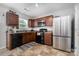 Modern kitchen with stainless steel appliances, dark wood cabinets, and tile flooring at 2046 E Park Dr, Lancaster, SC 29720
