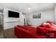 Spacious living room with hardwood floors, TV, and a comfortable red sectional sofa at 2046 E Park Dr, Lancaster, SC 29720