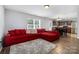 Cozy open floorplan featuring hardwood floors, TV, sectional sofa, and dining area with view into kitchen at 2046 E Park Dr, Lancaster, SC 29720
