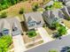 Aerial view of home with beautiful lawn, driveway and lush landscaping in quiet neighborhood at 3005 Oakmere Rd, Waxhaw, NC 28173