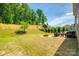 Spacious backyard featuring a fire pit and wooded area, ideal for outdoor relaxation and entertainment at 3005 Oakmere Rd, Waxhaw, NC 28173