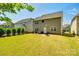 View of backyard featuring well maintained lawn, patio, a fire pit and privacy fence at 3005 Oakmere Rd, Waxhaw, NC 28173