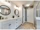Modern bathroom featuring double sinks, decorative mirrors, stylish lighting, and patterned accent wall at 3005 Oakmere Rd, Waxhaw, NC 28173