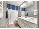 Cozy bathroom featuring a double vanity, large mirror, and shower with a patterned curtain at 3005 Oakmere Rd, Waxhaw, NC 28173