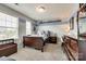 Bedroom with a sports-themed design, two windows, and dark wood furniture at 3005 Oakmere Rd, Waxhaw, NC 28173
