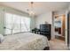Bedroom with a large window, chandelier, and adjacent room view at 3005 Oakmere Rd, Waxhaw, NC 28173