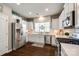 Beautiful kitchen with stainless steel appliances, white cabinetry, and hardwood floors at 3005 Oakmere Rd, Waxhaw, NC 28173