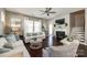 Comfortable living room featuring a fireplace, neutral colors, a ceiling fan, and lots of natural light at 3005 Oakmere Rd, Waxhaw, NC 28173