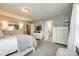 Bright and airy bedroom with soft colors, white furnishings, and adjoining bathroom at 3005 Oakmere Rd, Waxhaw, NC 28173