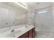 Bathroom featuring double sink vanity, large mirror, and a shower-tub combo at 3124 Arklow Rd, Charlotte, NC 28269