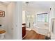 Bright bathroom featuring a separate shower and bathtub, vanity and tile flooring at 3124 Arklow Rd, Charlotte, NC 28269