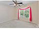 Cozy bedroom with a ceiling fan and a brightly lit window at 3124 Arklow Rd, Charlotte, NC 28269
