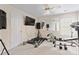 Bright exercise room featuring workout equipment, ceiling fan and wall mirror at 3124 Arklow Rd, Charlotte, NC 28269