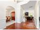 Bright entryway with hardwood floors, staircase and views into the dining and living spaces at 3124 Arklow Rd, Charlotte, NC 28269