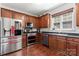 Modern kitchen featuring stainless steel appliances and dark wood cabinets at 3124 Arklow Rd, Charlotte, NC 28269