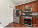This kitchen features wood cabinetry, modern stainless steel appliances, and hardwood floors at 3124 Arklow Rd, Charlotte, NC 28269