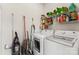 Well-organized laundry room featuring modern washer, dryer and ample storage shelves at 3124 Arklow Rd, Charlotte, NC 28269