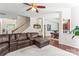 Open-concept living room with dark wood floors, modern furnishings, and a staircase at 3124 Arklow Rd, Charlotte, NC 28269