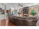 Spacious living room with dark wood floors, ceiling fan, fireplace, and exterior views at 3124 Arklow Rd, Charlotte, NC 28269